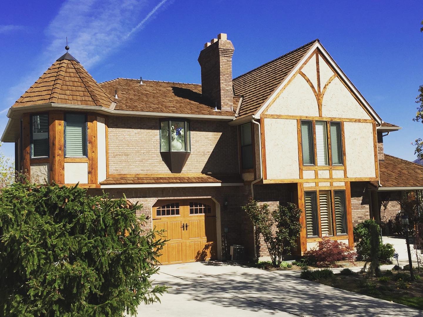 CeDUR synthetic cedar shake roof on a Tudor-style brick home