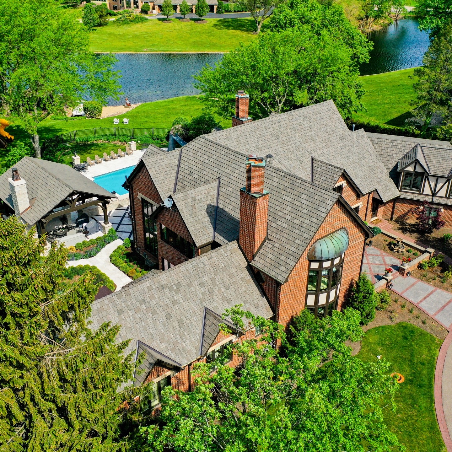 Brava composite cedar shake roof on a Tudor-style estate home, aerial view