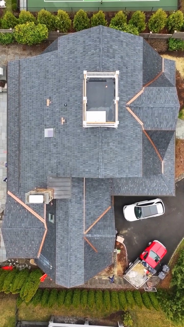 Top-down view of a Brava composite slate roof with copper valleys